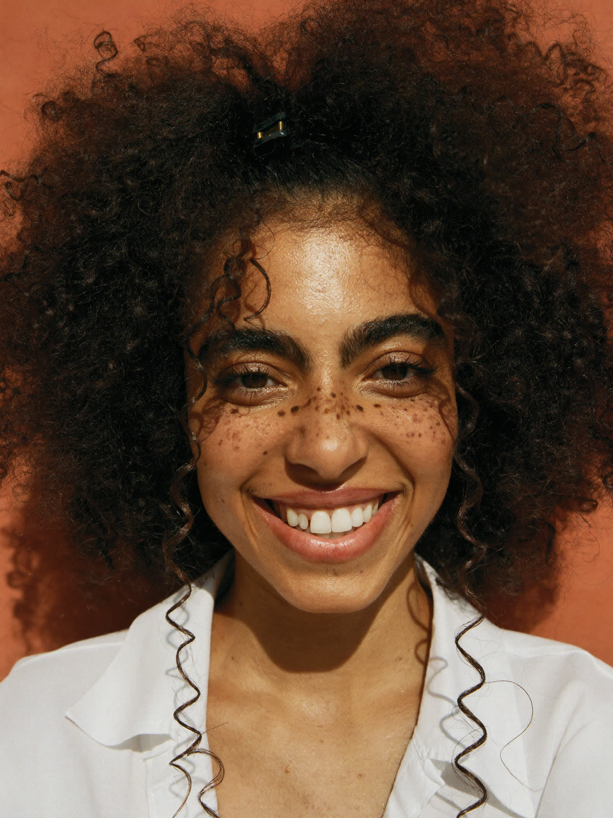 AI-generated models of different skin tones and features, smiling portraits