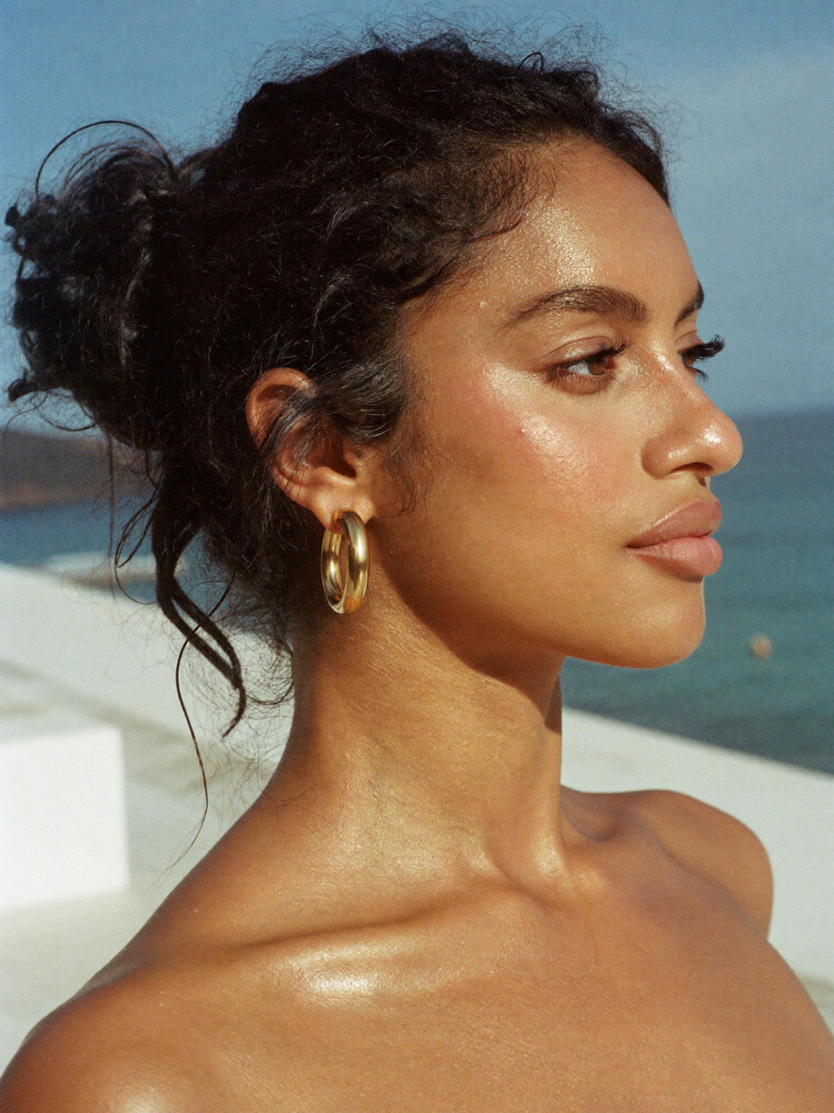 AI jewelry visual: model wearing gold hoop earrings